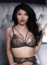 Xena Lynn the hot oriental t-girl with a huge dick pleasures herself until she cums hard